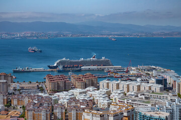 View from the Rock of Gibraltar to the bay of Gibraltar full of ships on the roadstead and The Port of Algeciras. Incredible skyline, blue sky with amazing clouds. Gibraltar, UK