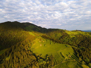 Evening view of the green hills. Beautiful sunset light. Hiking in Carpathian mountains, Ukraine.