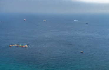 October 17th, 2022. Sea disaster in Algeciras Bay. View from The Rock of Gibraltar. Closeup photo. A close up of the sinking ship and the auxiliary and rescue units working around it.   Gibraltar, UK