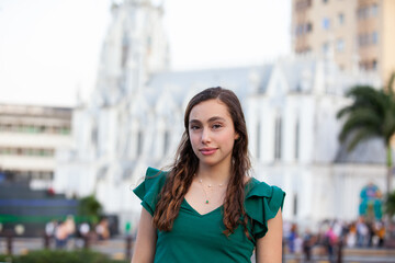 Beautiful tourist girl at the Ortiz Bridge with La Ermita church on background in the city of Cali in Colombia