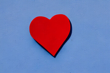 Illustration of a red heart on a blue blackground, valentine's day card concept, love card concept, made with generative AI Technology