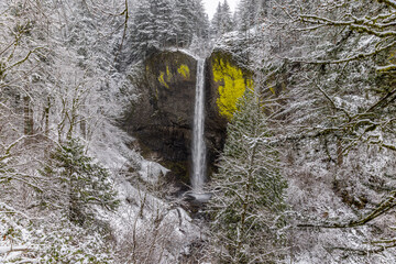 View at Latourell Falls after winter storm in Columbia River Gorge, Oregon. Scenic waterfall during winter time