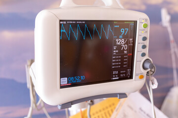 Medical vital signs monitor instrument in a hospital display and monitors heart rate and oxygen levels in hospital patient