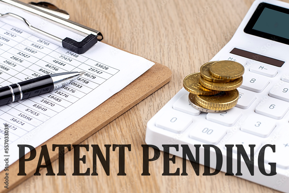 Poster patent pending text with chart and calculator and coins , business concept