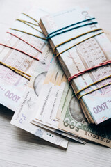 Three bundles of Ukrainian hryvnia money lie in a pile. Currency of Ukraine. monetary system