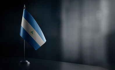 Small national flag of the Nicaragua on a black background