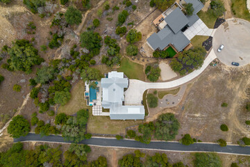looking down at a house with a long driveway 