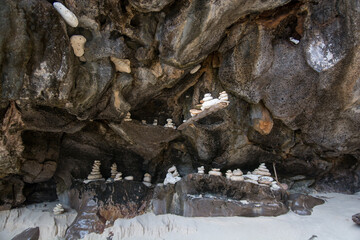 Some pyramids from little rocks on the many ledge in the rock