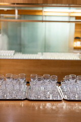 many drinking glasses on trays