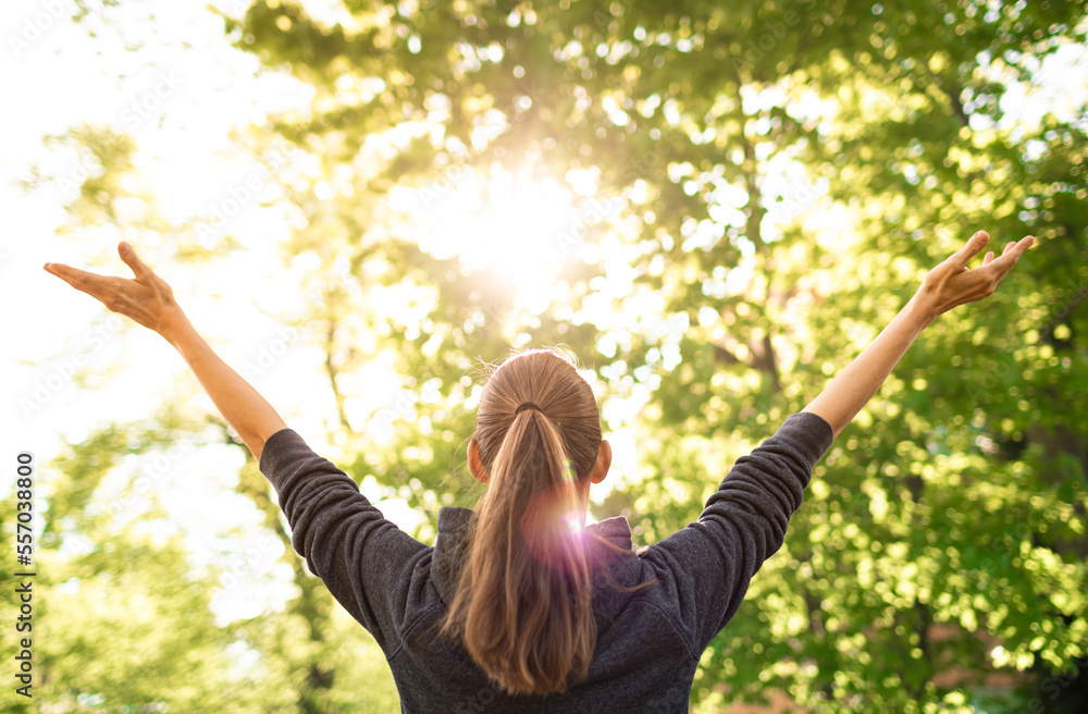 Wall mural young woman feeling alive feel good in nature