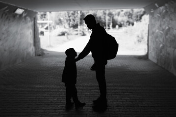 silhouette of father and son parent talking to child. Parenting concept. 