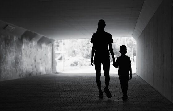 Silhouette Of Mother Child Walking Holding Hands 