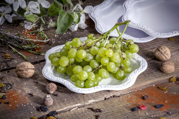 A bunch of green grapes on a disposable eco cardboard plate