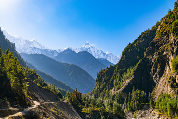 Annapurna circuit trek path with sweeping view of the mountains and valleys on a sunny fall day