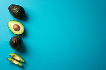 Fresh avocados on a blue background. Banner with free space for text. Healthy Eating.
