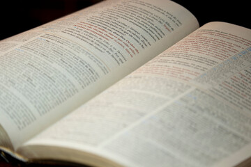 holy bible used for studies, open in half on a pulpit