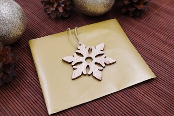 Gold envelope with wooden star. Gift for holidays.