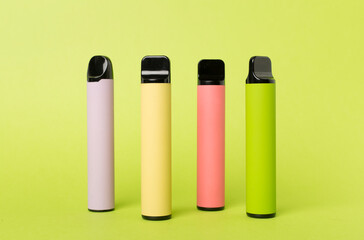 Disposable electronic cigarettes on color background