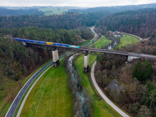 Aerial view of a railroad bridge with train