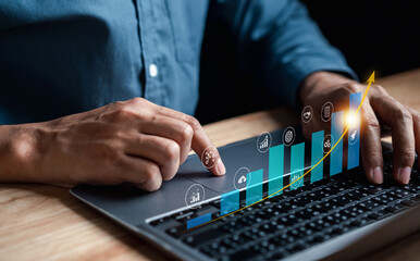 target on business investing concept, Businessman analyzing company financial balance sheet working with digital graphics. Businessman calculates financial data for long-term investment.