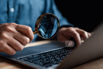 Businessman use magnifying glass Search On Virtual Screen Data Search Technology Search Engine Optimization. Man use computer to Searching for information. Using Search Console for data. - obrazy, fototapety, plakaty