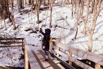 beautiful woman walking in snowy park in winter