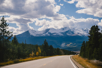 Road trip imagery - driving on an open road through the Colorado Rocky Mountains in the fall