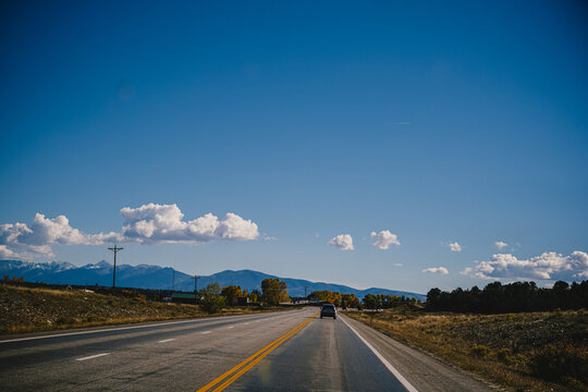 Road Trip Imagery - Driving On An Open Road Through The Colorado Rocky Mountains In The Fall