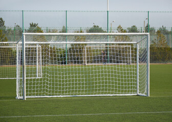 empty goal for playing mini football on the green lawn of the stadium. preparation for the football championship. green artificial turf for sports
