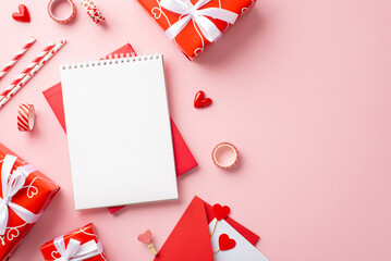 Valentine's Day concept. Top view photo of notepads red gift boxes with bows straws decorative tape hearts clips and envelope with letter on isolated pastel pink background with blank space