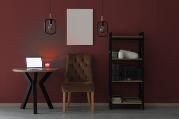 Brown velor armchair against a wall and an empty picture	