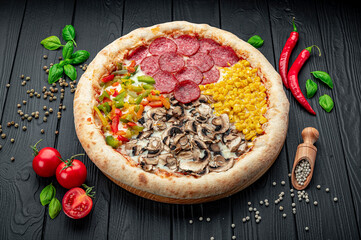Tasty fresh pizza with four different pieces in one on wooden background. Top view of big pizza