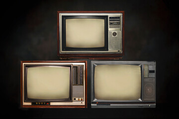 Three old-fashioned TVs with empty screens stacked in dark. Retro old television set pile on black background.
