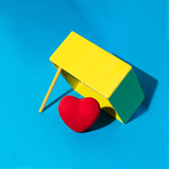 Red heart in a trap on blue background. Modern Valentine's Day concept. Creative love idea. Minimalistic holiday composition.