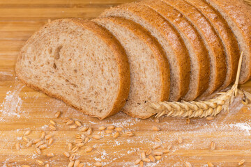 Slices of bread with bran among the ears and grain