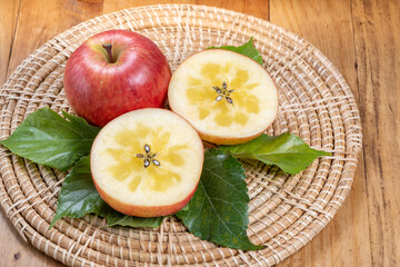 Honey apple on wooden mat over wooden background table, Sweet honey core apple fruit on wooden...