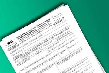 Form 8858 documentation published IRS USA 09.30.2021. American tax document on colored