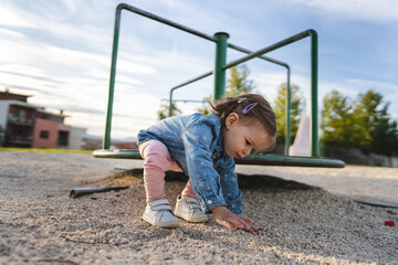 One girl small caucasian child female toddler 18 months old in park play in day by speedy spinner...