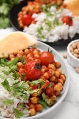 Plate with delicious chickpea curry on table, closeup