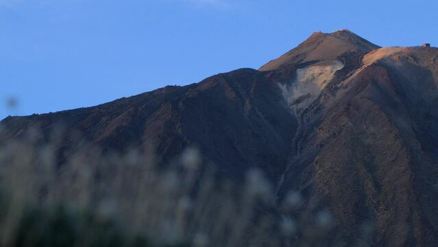 Summit of Teide volcano, scenic landscape at Teide National Park in Tenerife at Canary Islands of Spain, volcanic nature, sunny evening before the sunset, golden hour, distant medium shot