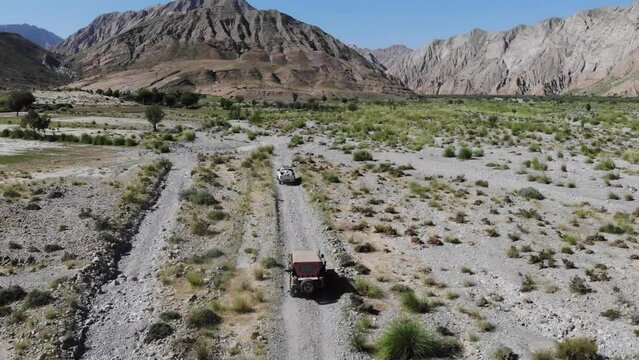 Aerial shot of car running in the mountain road in the morning time.