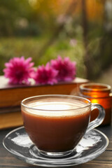 Glass cup with coffee on wooden table. Morning ritual