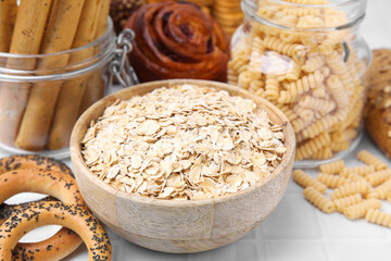 Different gluten free products on white tiled table, closeup