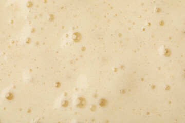 Tasty smoothie with bubbles as background, closeup