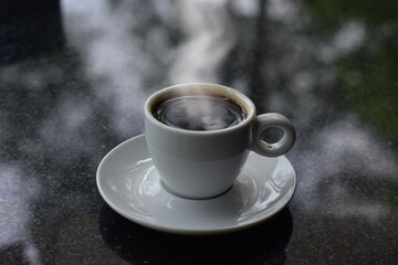 Coffee is a hot, smoky cup of coffee lying on the floor.