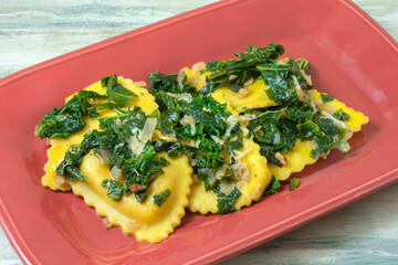 Butternut squash and cheese agnolotti pasta with kale shallot and nuts