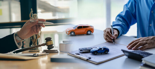 justice statue Hammer and car on wooden background Judge hammer with toy car and papers Car auction close up, car keys on table in office