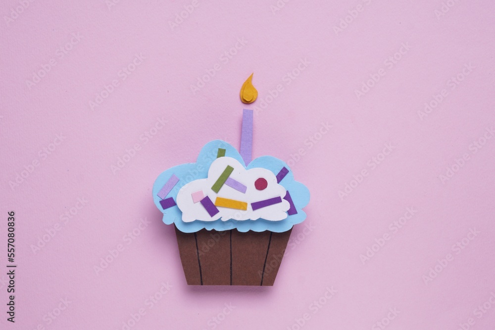 Wall mural Birthday party. Paper cupcake on pink background, top view