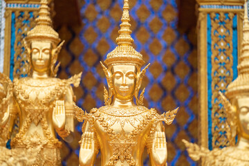 Fototapeta na wymiar A Lot of Golden Statue standing in the temple