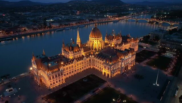Aerial view of the illuminated Hungarian Parliament Building with the Danube river. Budapest, Hungary. Travel, tourism and European Political Landmark Destination